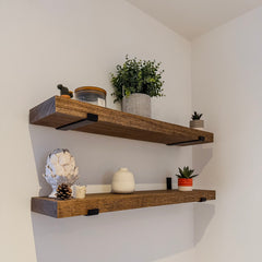 Wooden shelves with decorative items against a white wall