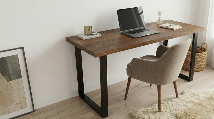 Wooden desk with a laptop, chair, and decor items in a room.